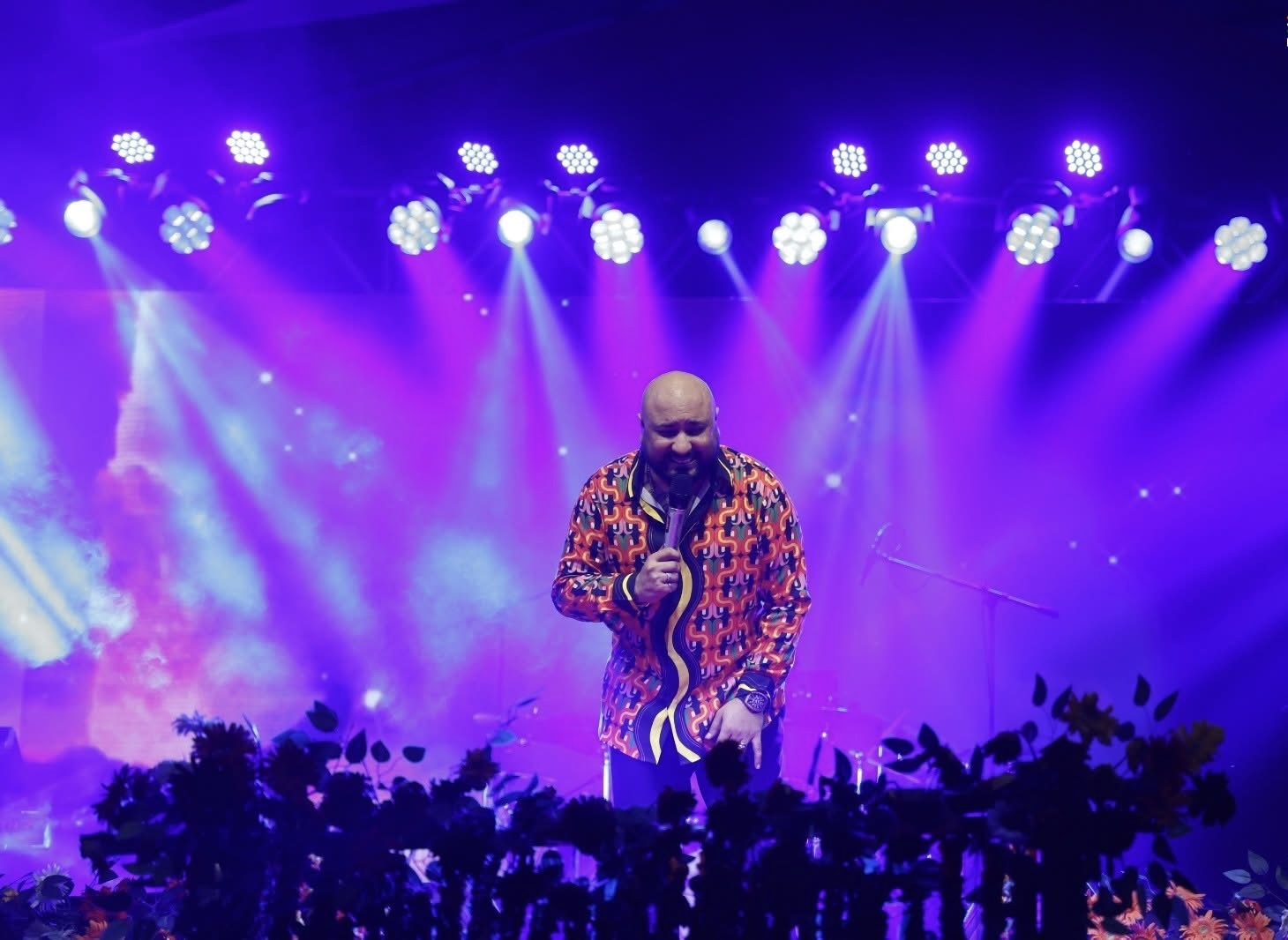 Live singer under purple lighting